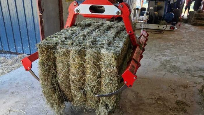 balle carrée sortant de la presse à poste fixe